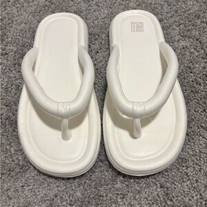 Woman’s White Flip Flops